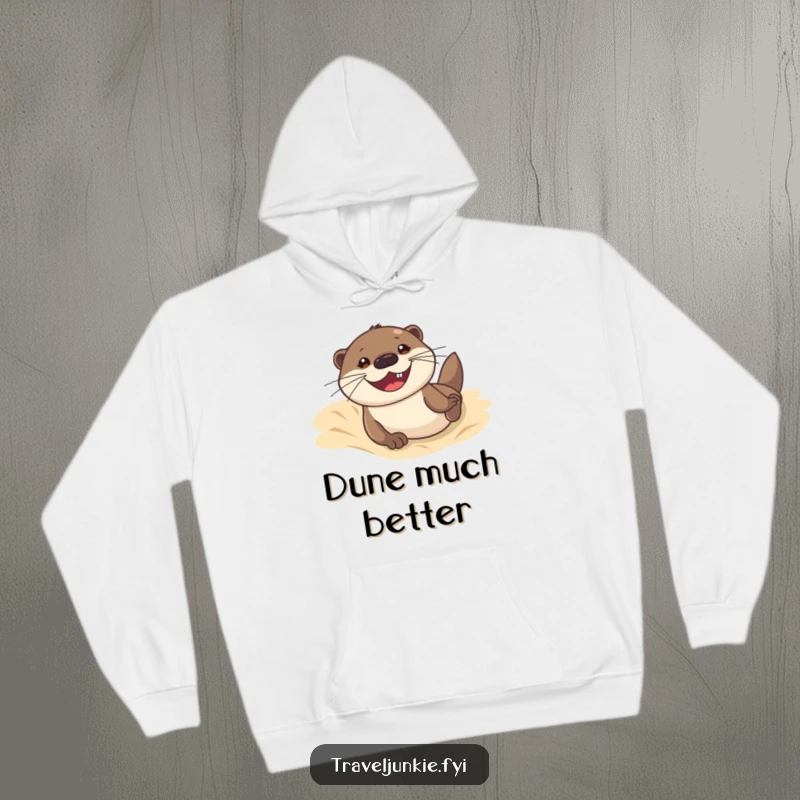 Funny hoodie featuring an otter sliding down a sand dune with a grin, ideal for cozy wear and expressing a love for beach fun.