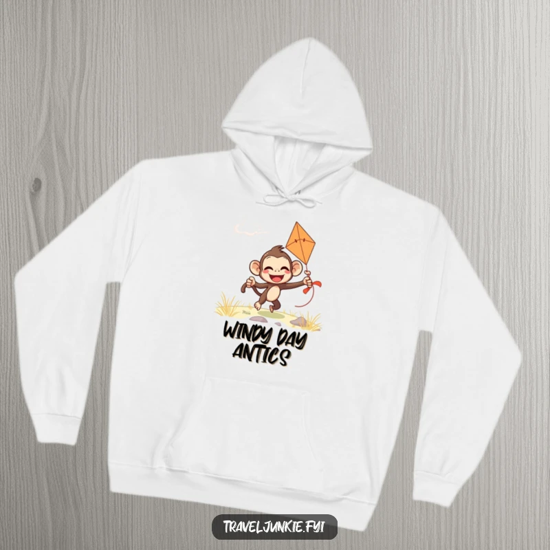 Funny monkey hoodie featuring a giggling character comically attempting to fly a kite on a windy day, ideal for cozy relaxation.
